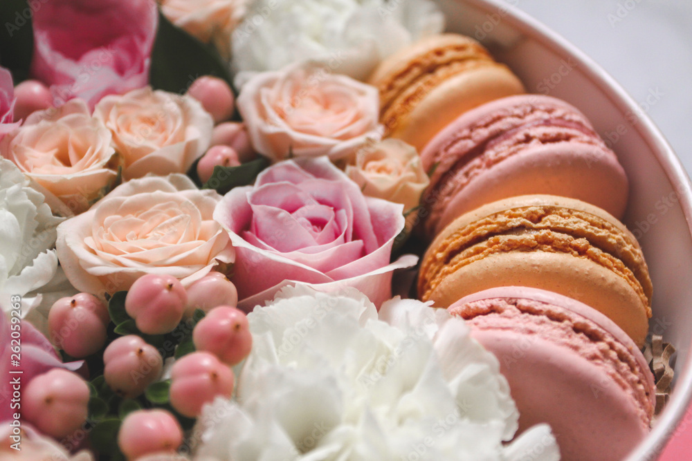 Beautiful floral background in the Box with the macaroons on top of the background Beautiful floral background in the Box with the macaroons on top of the background