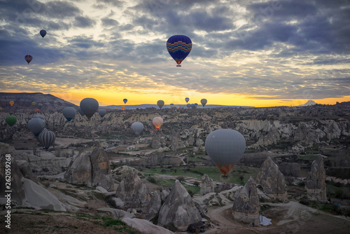 Hot Air balloons flying tour over Mountains landscape spring sunrice Cappadocia, Goreme Open Air Museum National Park, Turkey nature background. photo