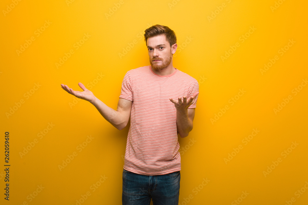 Young redhead man confused and doubtful Young redhead man confused and doubtful