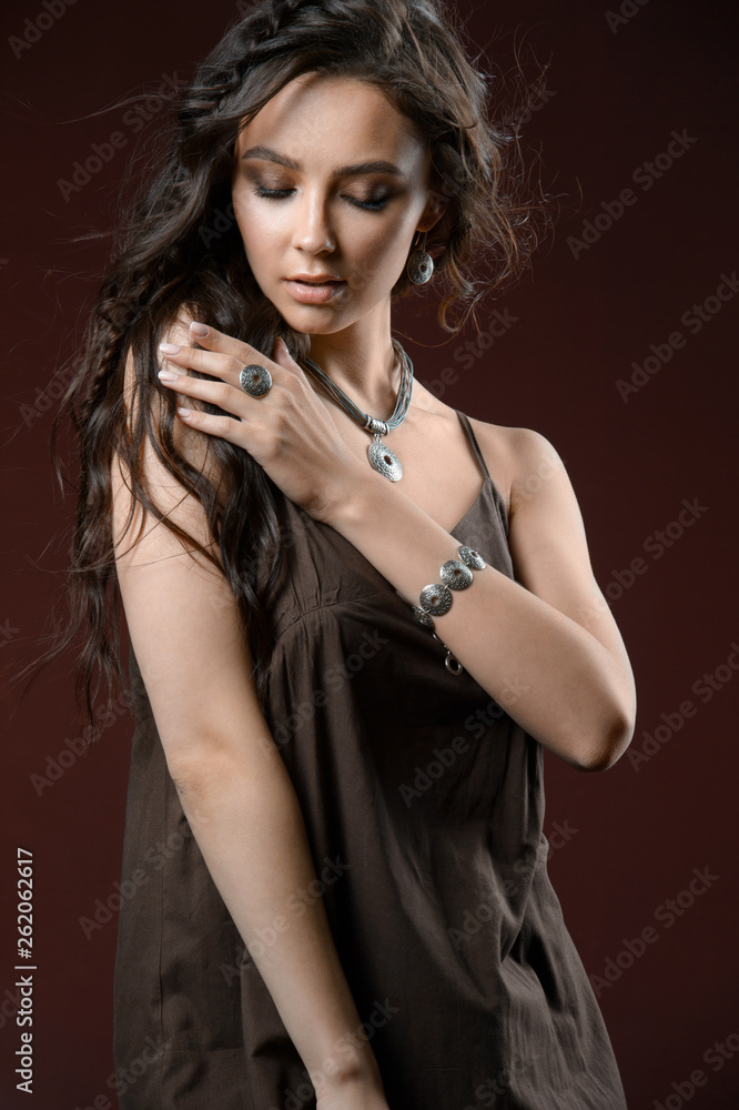 Fototapeta premium Elegant silver accessory on woman. Necklace on neck, earrings and the ring.
