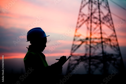 Silhouette of asian engineer working on sunset,Thailand people work on sunset