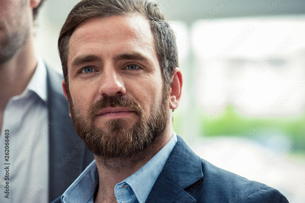Thoughtful businessman standing in hotel lobby Thoughtful businessman standing in hotel lobby
