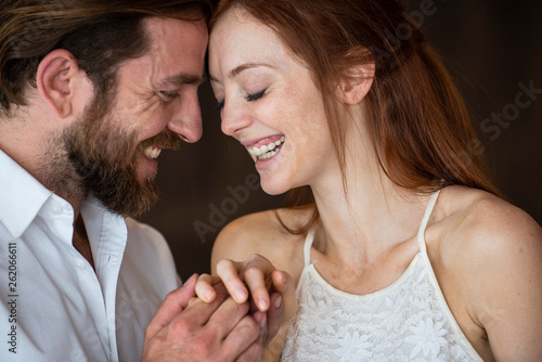 Smiling couple touching heads in a bar