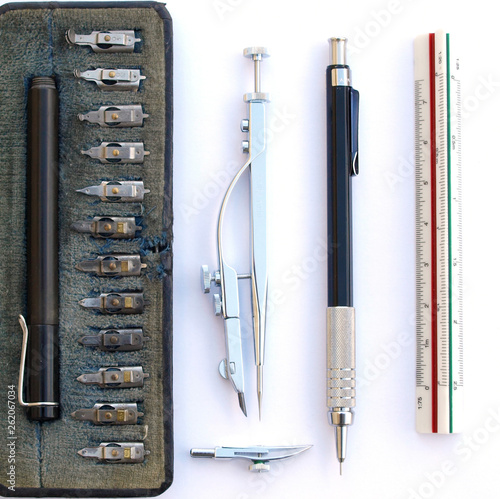 intage classic drafting drawing tool set: compass, rule, mechanical pencil and technical pen zenital view over white background photo