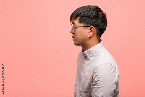 Young chinese man on the side looking to front