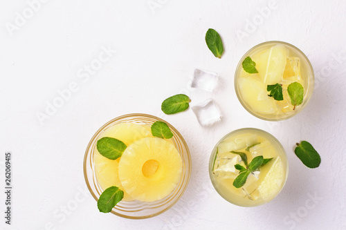 Infused water with pineapple and mint on whit background.