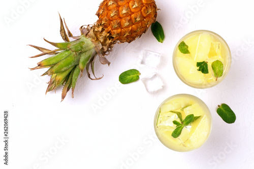 Infused water with pineapple and mint on whit background.