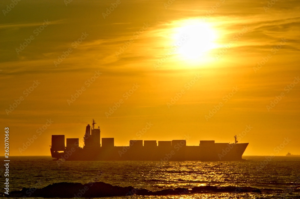 Sunset with a ship cargo in Portugal