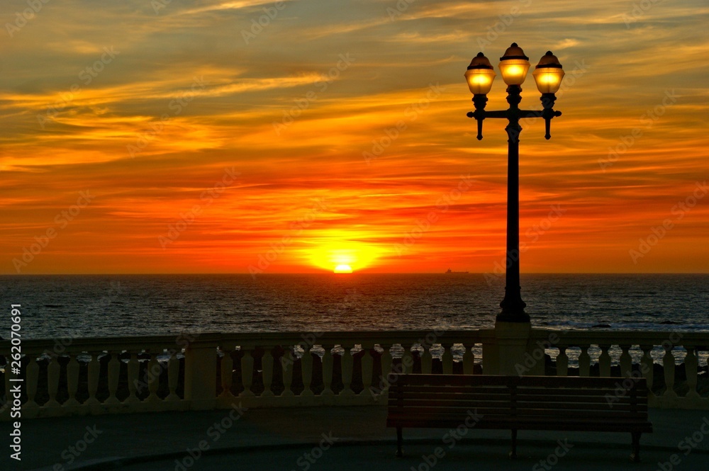 Beach sunset with lamps in Oporto, north of Portugal