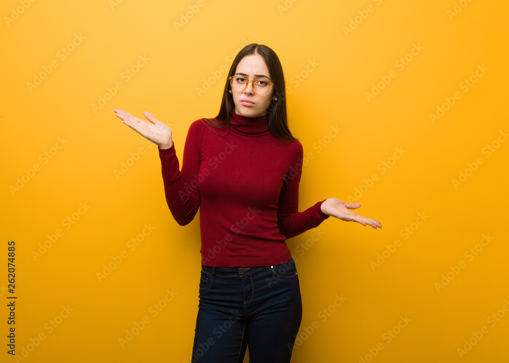Intellectual young girl confused and doubtful Intellectual young girl confused and doubtful