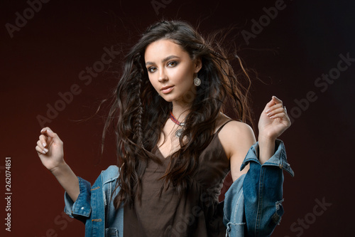 Jewelry concept. Beauty portrait of a beautiful female model posing isolated on brown background