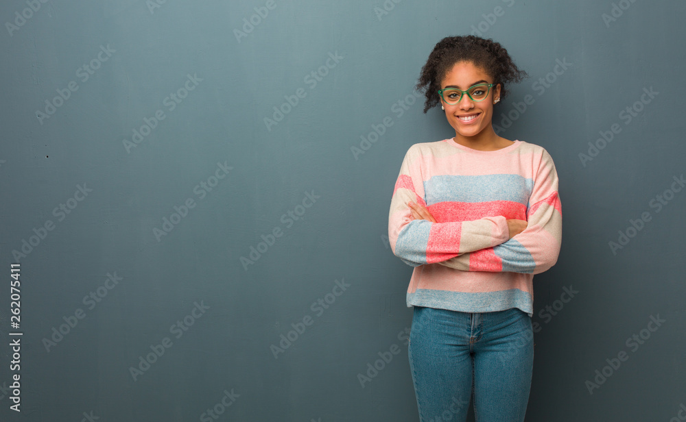 Young african american girl with blue eyes crossing arms, smiling and relaxed Young african american girl with blue eyes crossing arms, smiling and relaxed