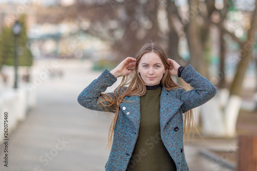 Girl in a coat in the alley on the Volga river in Cheboksary photo