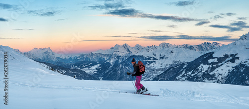 Switzerland, Bagnes, Cabane Marcel Brunet, Mont Rogneux, woman ski touring in the mountains at dusk photo