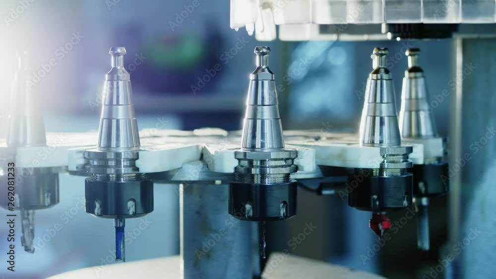 Automatic change of milling heads in modern CNC machining center Automatic change of milling heads in modern CNC machining center