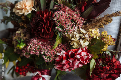 bright burgundy red flower bouquet on a chair with letter. vintage style. close-up © magic_cinema