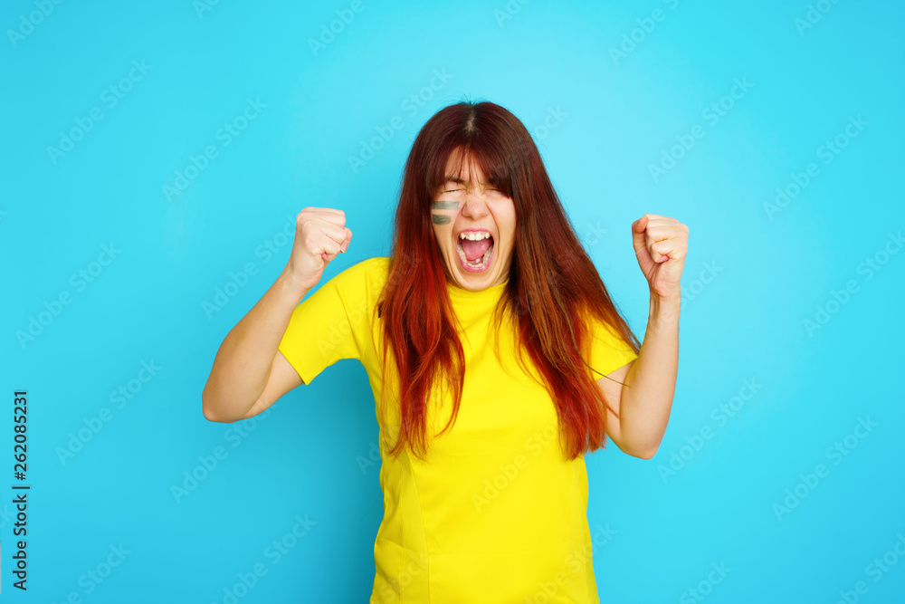 Woman is socccer fan in yellow t-shirt Woman is socccer fan in yellow t-shirt