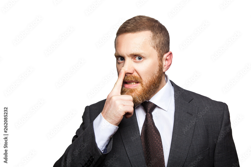 Closeup portrait of handsome serious businessman with facial beard in black suit standing and touching his nose and showing lie gesture. indoor studio shot isolated on white background. Closeup portrait of handsome serious businessman with facial beard in black suit standing and touching his nose and showing lie gesture. indoor studio shot isolated on white background.