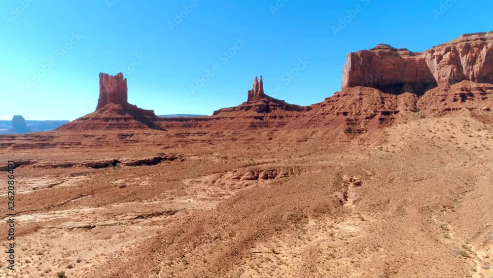 The surreal sandstone towers in Monument Valley Navajo Tribal Park. 4K drone shot of the most notable landmark of the Southwest. The surreal sandstone towers in Monument Valley Navajo Tribal Park. 4K drone shot of the most notable landmark of the Southwest.