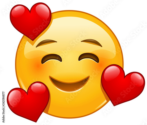 Smiling emoticon with 3 hearts