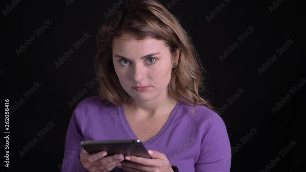 Portrait of woman working with tablet gets a great shock on black background. Portrait of woman working with tablet gets a great shock on black background.