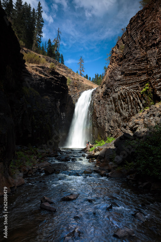 Two women escape the summer heat hiking in to the swimming below the Middle Falls at Elk Creek Falls in northern Idaho in the Nez Perce - Clearwater National Forest. The 2 mile loop trail (the remnants of an old wagon trail), takes you to Upper, Middle, and Lower Elk Creek Falls. photo