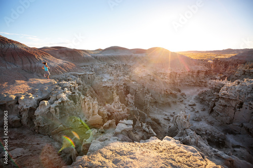 A woman goes for a run at the remote Fantasy Canyon, Utah during a quick stop to explore the delicate, otherworldy sandstone formations at this small-but-fascinating 10-acre preserve at sunset.