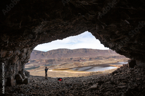 A man stands in one of the Lenore Caves in the scablands of central Washington. The caves were inhabited off and on for thousands of years by Native American hunting and foraging parties. photo