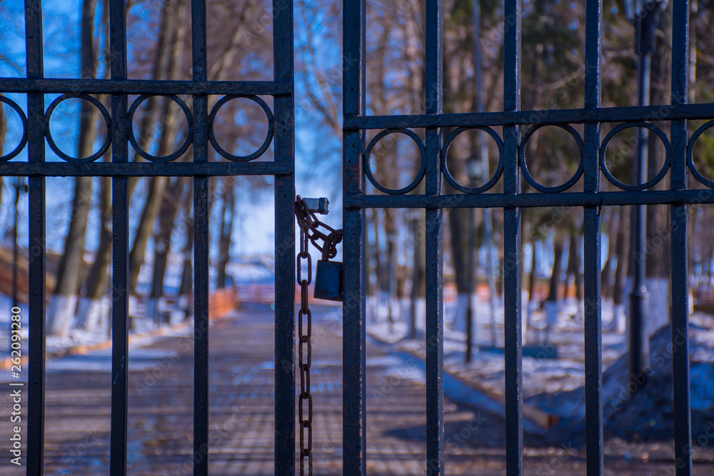 metal gate to the Park is closed with a lock and an iron chain
