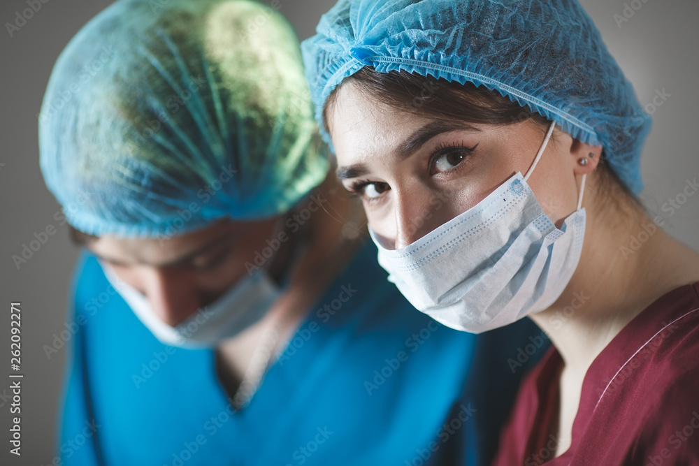 Portrait of surgeons at work, operating in uniform, looking at camera. Portrait of surgeons at work, operating in uniform, looking at camera.