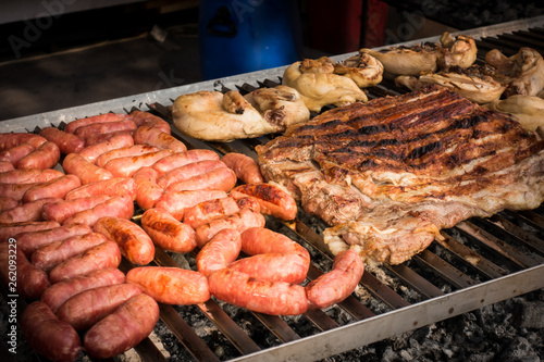 Meat baked on the grill. Sausages homemade sausages on the grill. Street food. Festival of street food and meat.