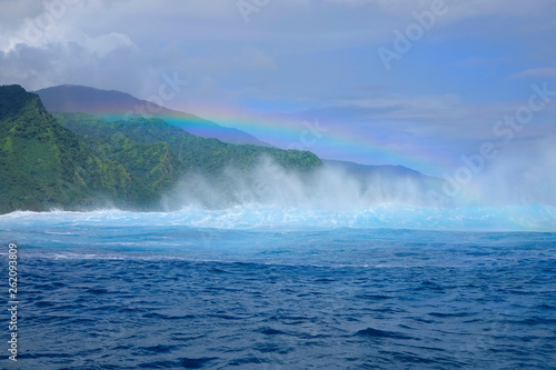 DRONE: Flying towards the beautiful breaking teahupoo wave in sunny Tahiti.
