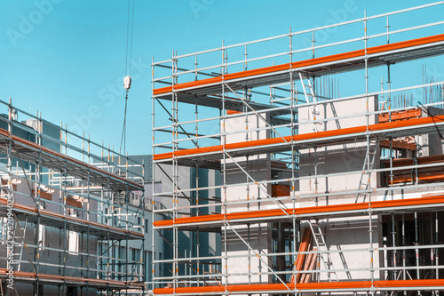 building under construction - construction site with scaffolding at the facade photo