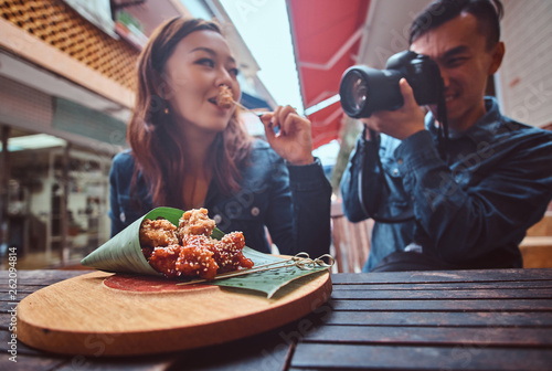 Young asian couple enjoy chinese food and photo shooting