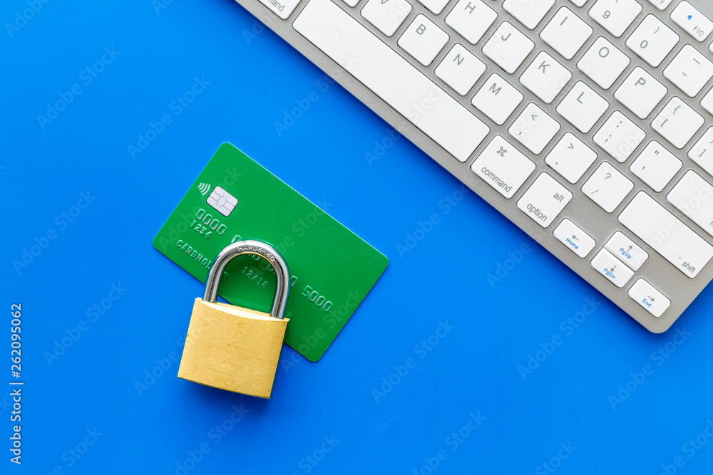 protect information from cyber attack with credit card, locker and keyboard on blue background top view protect information from cyber attack with credit card, locker and keyboard on blue background top view