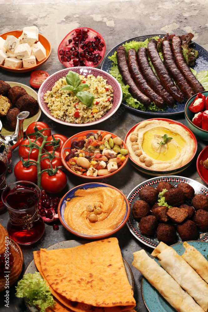 Middle eastern or arabic dishes and assorted meze, concrete rustic background. Falafel. Turkish Dessert Baklava with pistachio. Halal food. Lebanese cuisine Middle eastern or arabic dishes and assorted meze, concrete rustic background. Falafel. Turkish Dessert Baklava with pistachio. Halal food. Lebanese cuisine