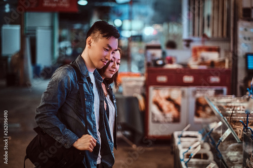 Photography Smiling asian couple are choosing seafood at market.