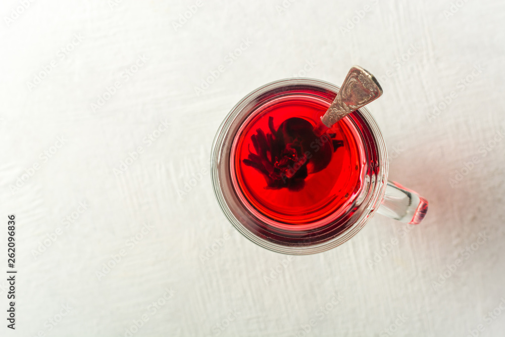 Transparent glass Cup with hot red tea from hibiscus or hibiscus. Transparent glass Cup with hot red tea from hibiscus or hibiscus.