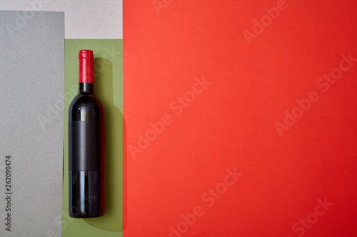 Layout of red wine on colorful geometry paper background