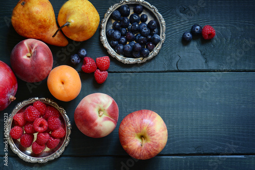 Variety of fresh fruit arranged on a wooden table photo