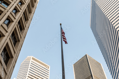 A united state flag among the skyscrapers of Seattle s financial district.