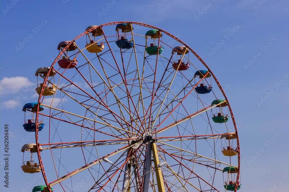 Ferris wheel in the park against blue sky. Ferris wheel in the park against blue sky.