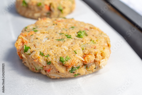 Best fish cakes raw uncooked on  baking tray. . Close up of crab patties.