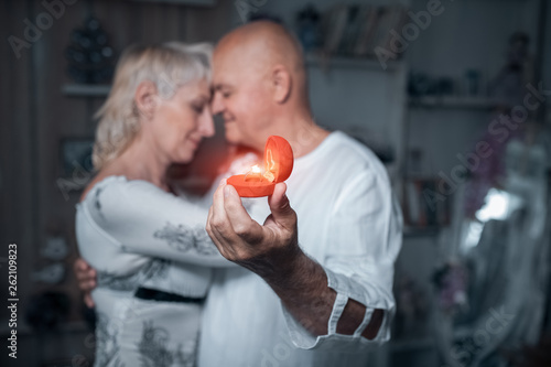 senior man making proposal to older woman;