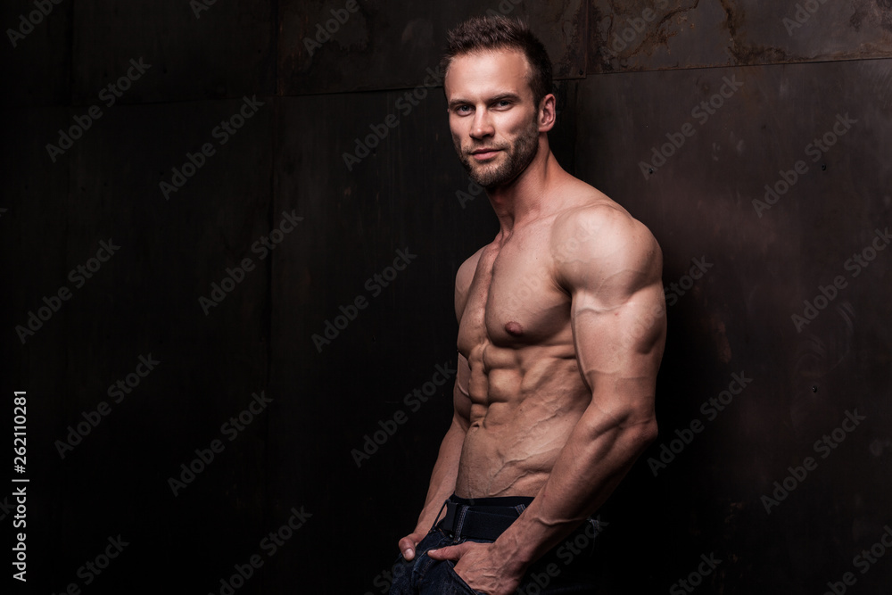 strong athletic man on dark grunge background strong athletic man on dark grunge background