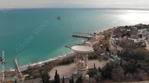 Radio telescope RT-22 in Simeiz Observatory, Crimea. Big white satellite dish antenna on sea coast for astronomy research, aerial view photo