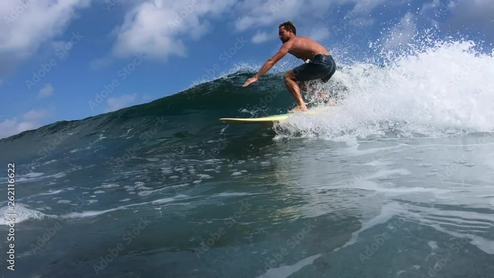 Surfer rides the wave in the ocean Surfer rides the wave in the ocean