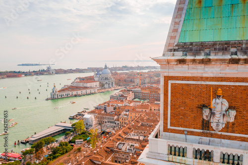 Architecture fragment of St Mark's Campanile (Campanile di San Marco) - famous bell tower of St Mark's Basilica and Loggetta at Piazza San Marco in Venice, Italy. photo