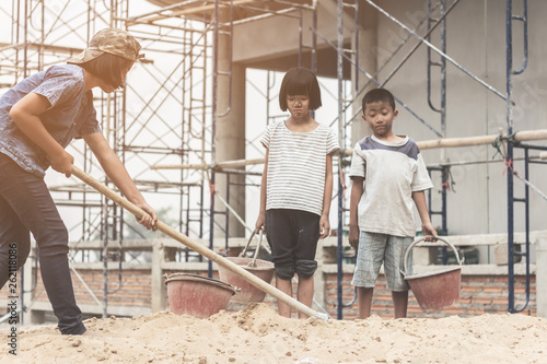 Children working at construction site for world day against child labour concept: