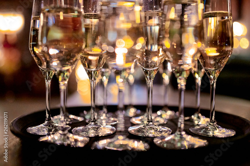 glasses with white wine on a tray